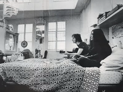 John Lennon and Yoko Ono in their Bank Street apartment, where you can spot the spiral staircase to the roof in the background.